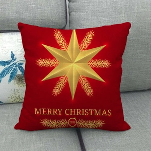 Detailed view of red linen pillowcase with golden star and Merry Christmas print