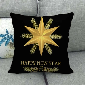 Detail of black linen cushion cover with gold Happy New Year star print on sofa
