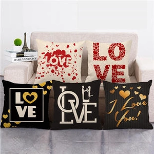 Detail of linen pillowcases featuring assorted red and gold heart patterns for Valentines