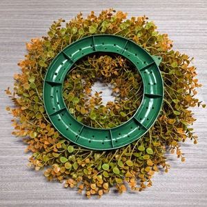 Detail of the sturdy plastic base and lush autumn eucalyptus leaves on the wreath back