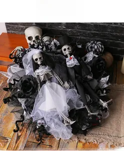 Macro view of Halloween skull bride and groom wreath with lace and striped pumpkin decor