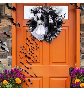 Halloween wreath with skeleton bride and groom dolls hanging on an orange door