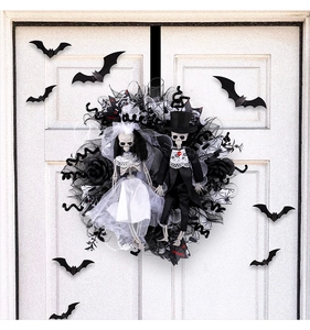 Close-up of gothic Halloween bride and groom skeleton wreath with black mesh veil
