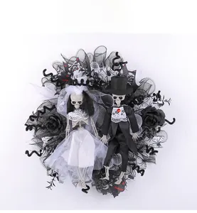 Detailed view of Halloween wreath with skeleton bride and groom dolls on black mesh