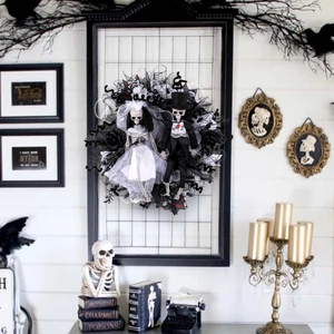Halloween wreath with skeletal bride and groom figures, black roses, and gothic mesh decor