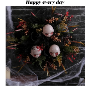 Detail of Halloween wreath with creepy baby heads, blood tears, and black spiders