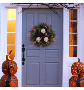 Close-up of Halloween wreath with three bloody doll heads and mesh on a front door