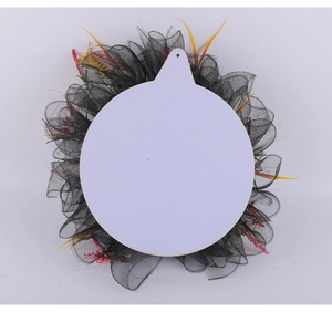 Detail view of Halloween wreath featuring black mesh, colorful flora, and white center board