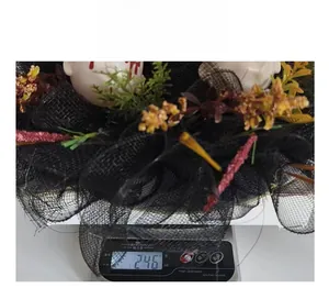Detailed view of Halloween skull wreath with black mesh on a scale weighing 246g