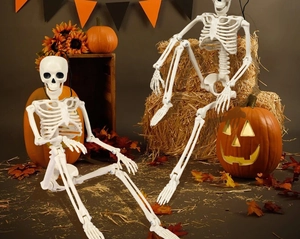 Close-up of flexible 40cm plastic skeletons in a festive Halloween garden setting
