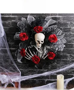 Macro shot of Halloween skull wreath with red roses, bone hands and black crow detail