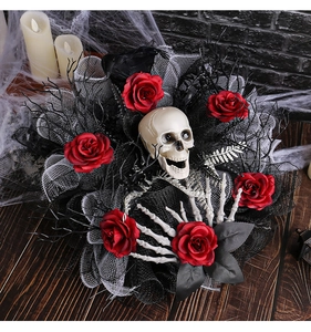 Gothic Halloween wreath with skull, red roses and black mesh on wood tabletop background
