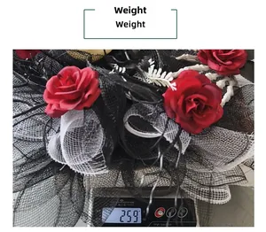 Detailed view of Halloween skull wreath with mesh roses on scale weighing 259g