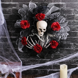 Halloween skull wreath with red roses, black crow and skeletal hands on a brick wall