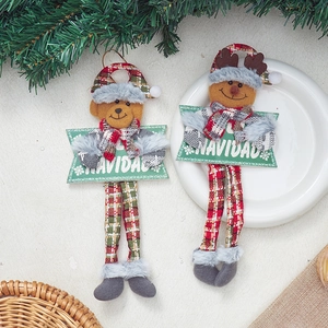 Detailed view of plush reindeer and bear Christmas ornaments with Navidad signs