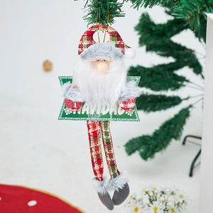 Detail of plush Santa ornament with Feliz Navidad text hanging on a Christmas tree