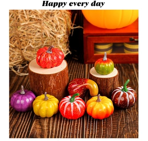 Detailed view of assorted artificial mini pumpkins in various colors for autumn harvest decor