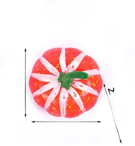 Detail of red foam pumpkin decoration with white stripes and green stem for harvest festivals