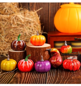 Detailed close-up of mini foam pumpkins in various colors on a rustic wooden stand