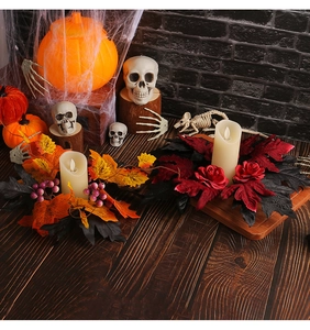 Close-up of Halloween candle ring featuring Gothic red roses and black leaves on dark wood