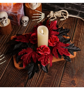 Detail of Halloween candle holder with red roses, maple leaves and LED electronic candle