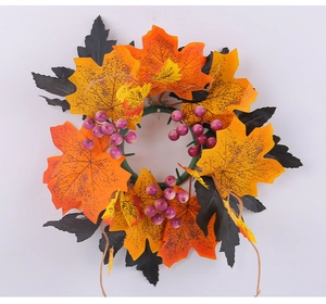 Macro shot of maple leaf wreath detail with vivid orange leaves and small berries