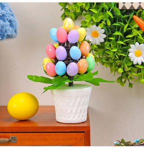 Close-up of Easter egg tree in white pot with colorful eggs and silver foil dots