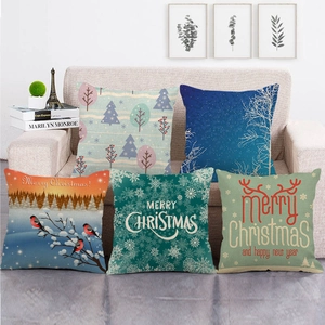 Detailed view of Christmas linen cushion covers with winter forest and snowflake patterns