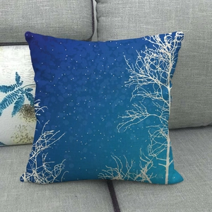 Detail of linen pillowcase featuring winter night sky with white tree silhouettes and snow