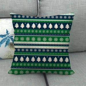 Close-up of a rustic linen Christmas pillowcase with snowflake and pine tree patterns