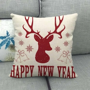 Macro detail of linen pillow cover with red reindeer and Happy New Year print
