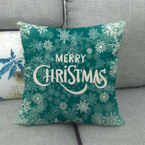 Close-up of linen Christmas pillowcase with snowflakes and Merry Christmas text on sofa