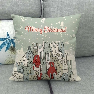 Detail of Christmas linen cushion cover featuring cartoon rabbits and Merry Christmas text