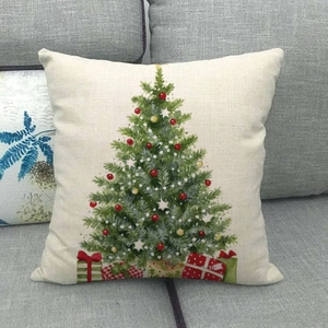 Detail of Christmas tree linen pillowcase on a grey sofa for holiday home decor