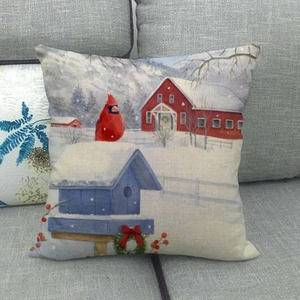Christmas linen pillow cover featuring a red cardinal bird and snowy winter barn scene