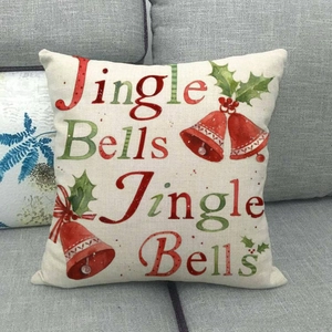 Close-up of linen Christmas pillowcase with Jingle Bells design on a grey sofa