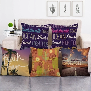 Close-up of five decorative linen pillow covers with watercolor coconut and palm tree prints
