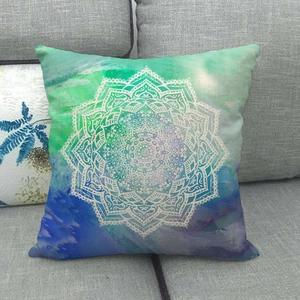 Close-up of mandala patterns and textured linen fabric on a blue gradient cushion cover