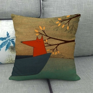 Linen pillowcase with cartoon fox on boat illustration shown on a grey fabric sofa