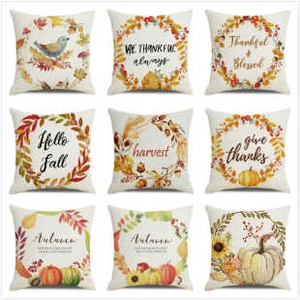 Detail set of nine linen pillow covers with fall motifs like pumpkins and sunflowers