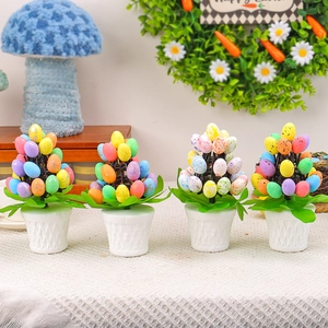 Set of four colorful Easter egg potted plants with speckled eggs and white ceramic pots