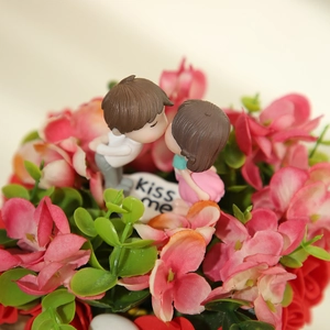 Romantic kissing couple figurines with heart tag in red and pink rose floral decor