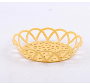 Détail du plateau de rangement rond jaune en plastique avec bords festonnés décoratifs