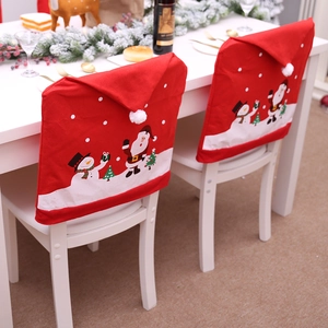 Set of two red Christmas chair covers with Santa and snowman prints on dining chairs