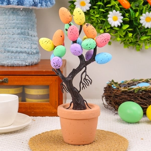 Easter egg bonsai tree with colorful spotted eggs in a brown pot for table decor