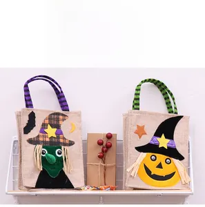 Detail of Halloween linen candy bags with witch and pumpkin appliques and striped handles
