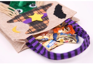 Detail of Halloween burlap candy bag with purple striped handle and cartoon hat applique