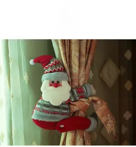 Detailed view of a Santa Claus plush curtain tieback on a soft patterned curtain