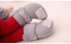 Close-up of Christmas doll legs with red felt, gray faux fur trim and Velcro fasteners