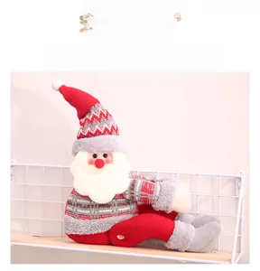 Detail of a plush Santa Claus curtain tieback with a red and grey knitted hat and white beard